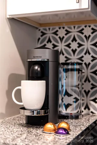a room with wooden cabinets and stainless steel appliances