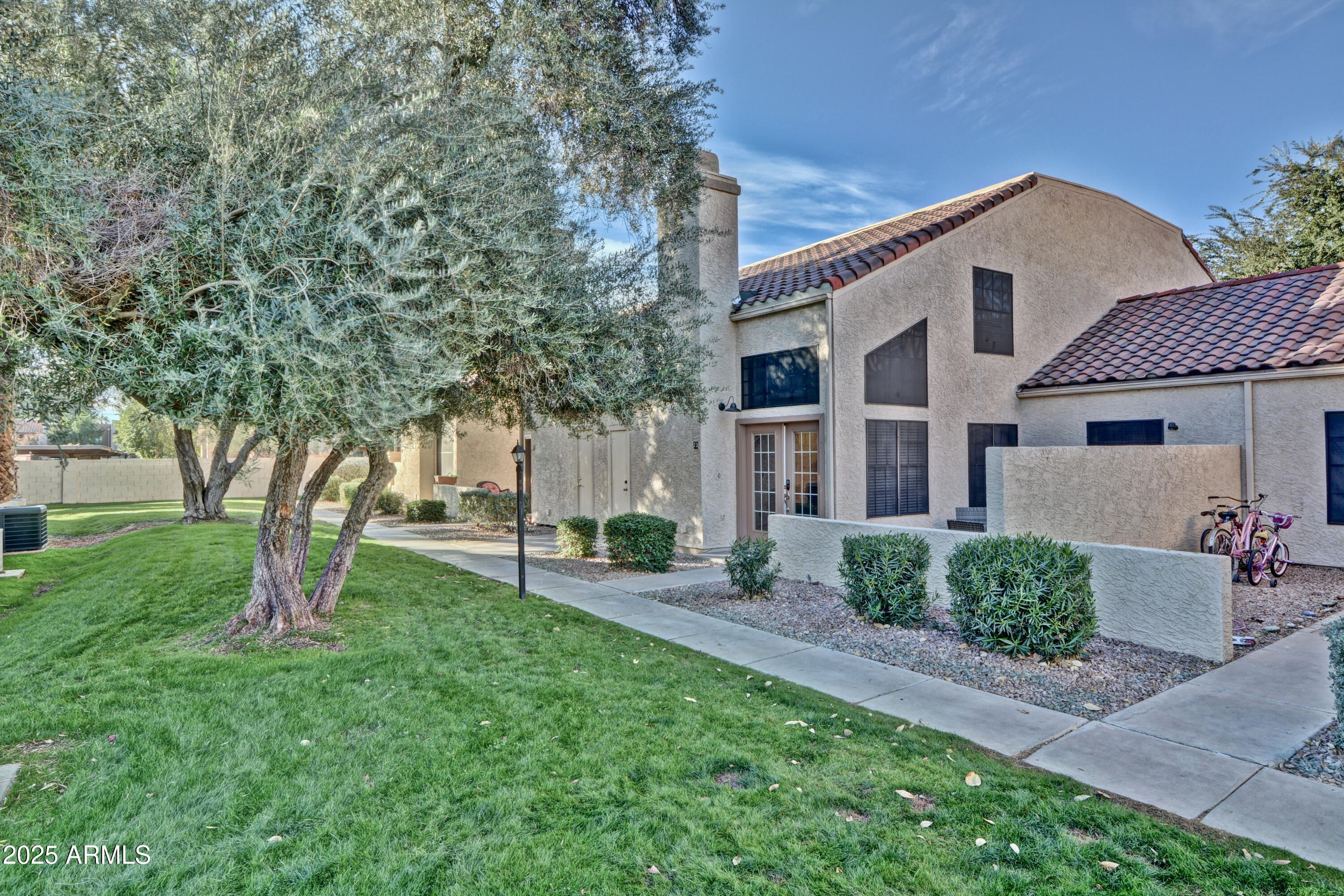 602 North May, Unit 23 Mesa, AZ 85201 - Photo 1 of 25 a porch with a table and chairs under an umbrella