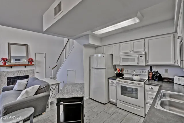 a kitchen with a refrigerator a stove a microwave and cabinets