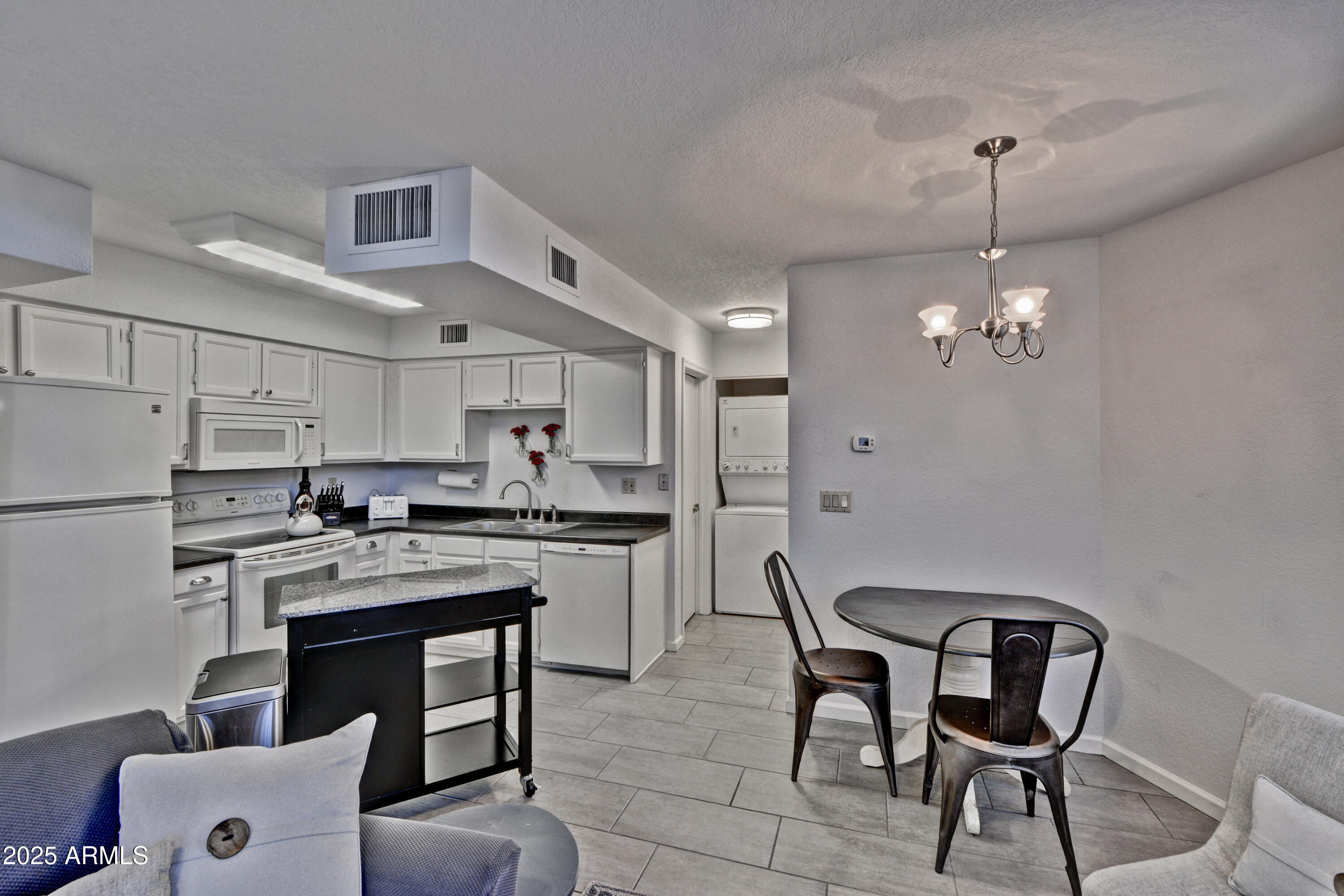 602 North May, Unit 23 Mesa, AZ 85201 - Photo 14 of 25 a kitchen with stainless steel appliances granite countertop a sink a stove a refrigerator and island