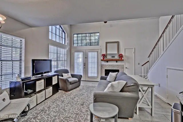 a living room with furniture a fireplace and a flat screen tv