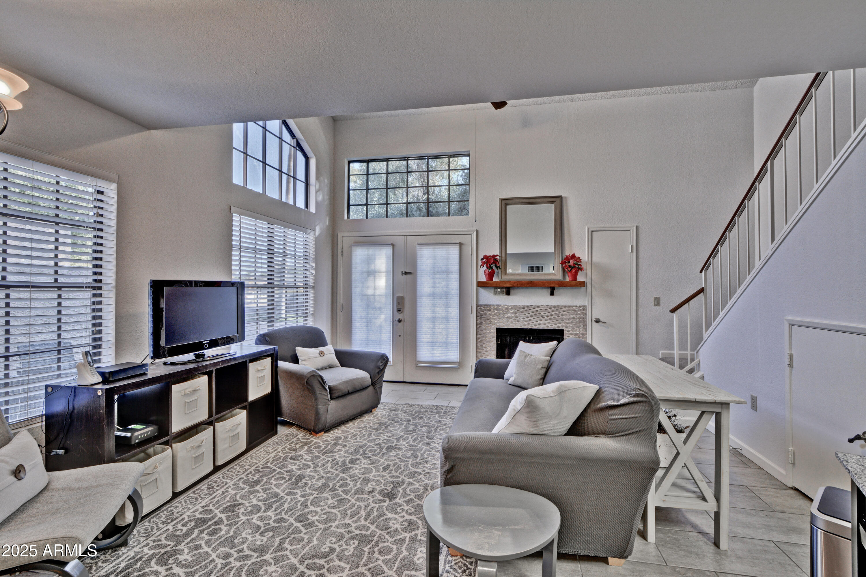 602 North May, Unit 23 Mesa, AZ 85201 - Photo 15 of 25 a living room with furniture a fireplace and a flat screen tv
