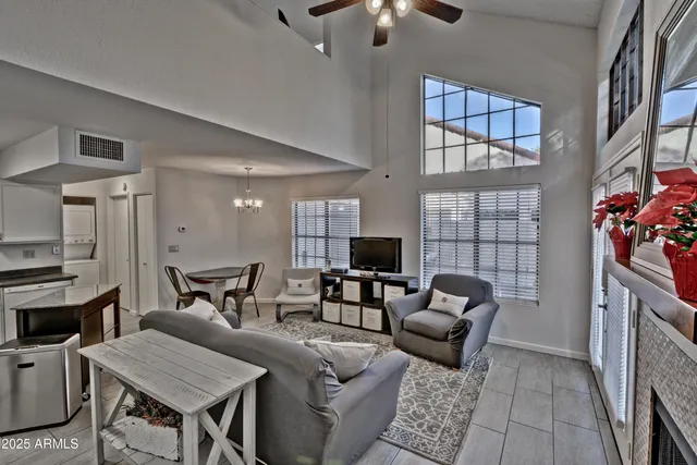 a living room with furniture and a chandelier