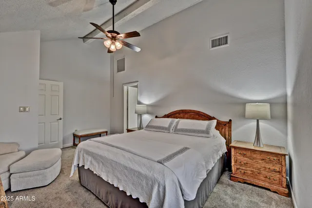 a bedroom with a bed and ceiling fan