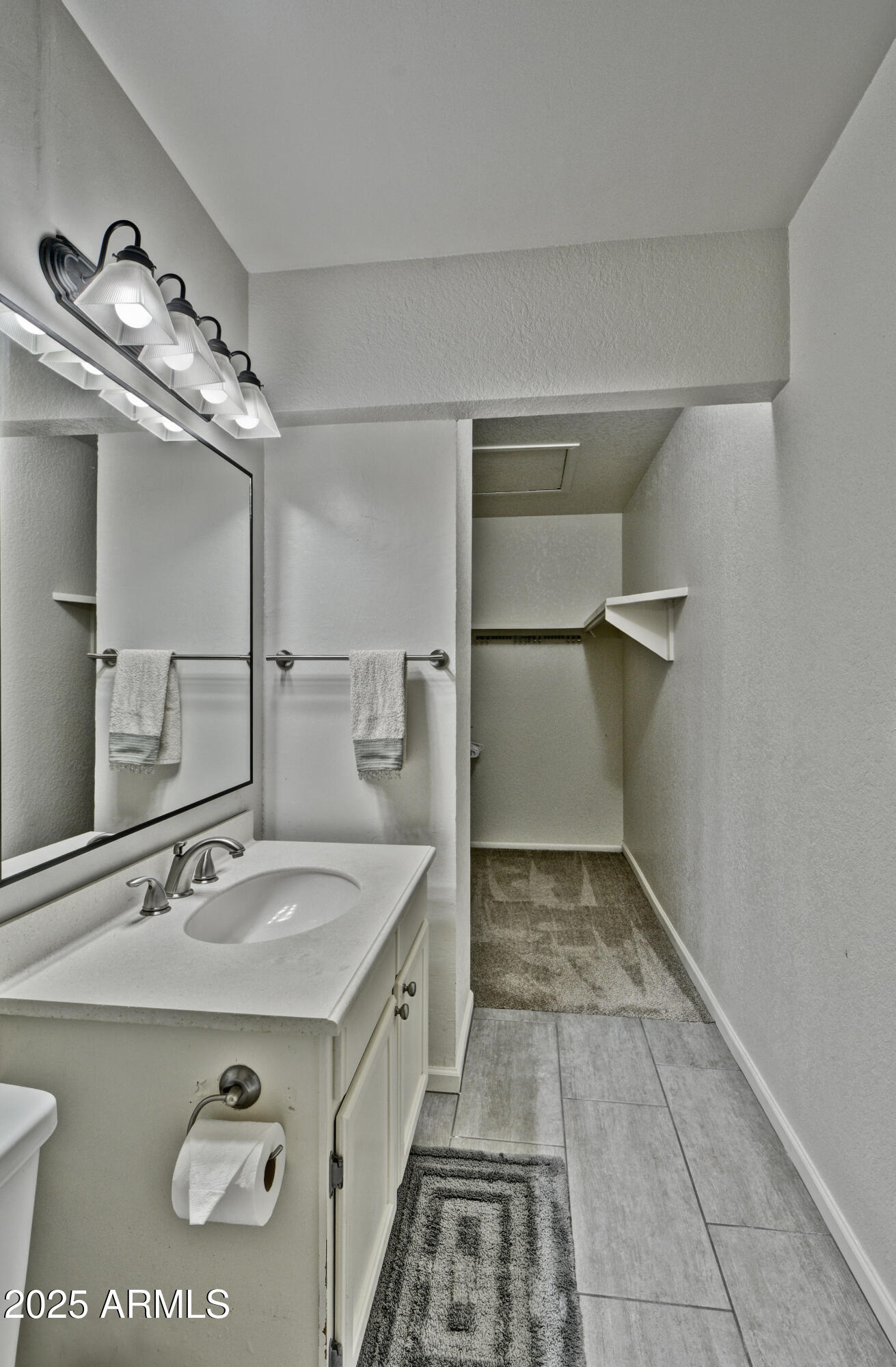 602 North May, Unit 23 Mesa, AZ 85201 - Photo 24 of 25 a bathroom with a sink and a mirror