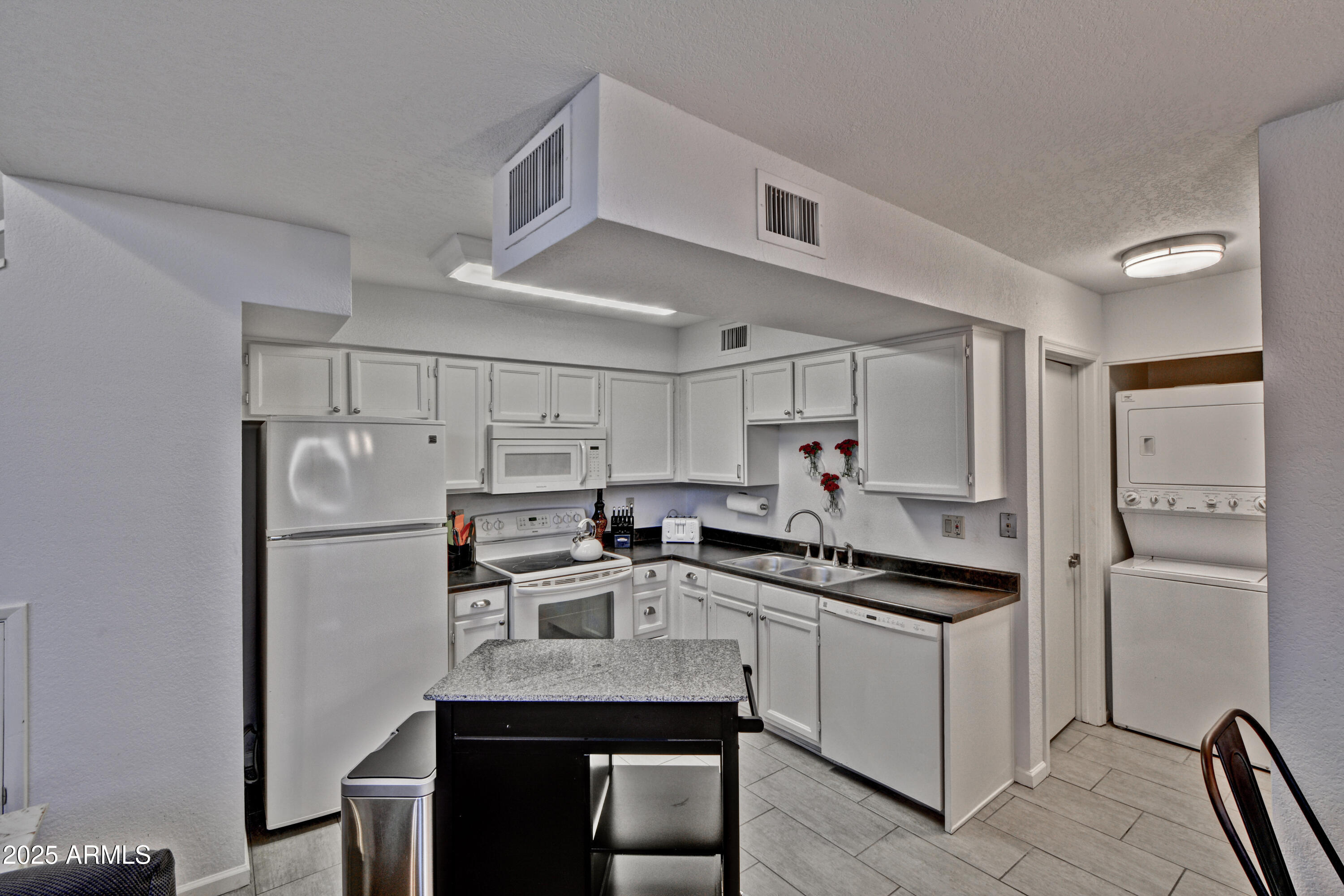 602 North May, Unit 23 Mesa, AZ 85201 - Photo 10 of 25 a kitchen with a sink a refrigerator a stove and cabinets