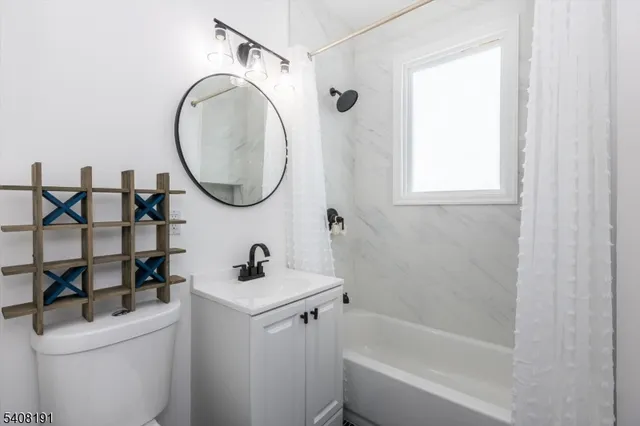 a bathroom with a sink toilet and a mirror
