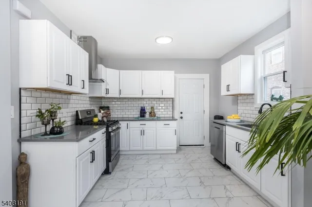 a kitchen with a white cabinets and white appliances