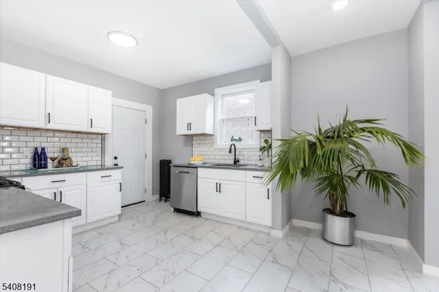 a kitchen with a white stove top oven and cabinets