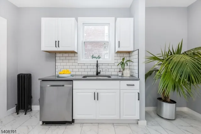 a kitchen with stainless steel appliances a white refrigerator a sink and a stove