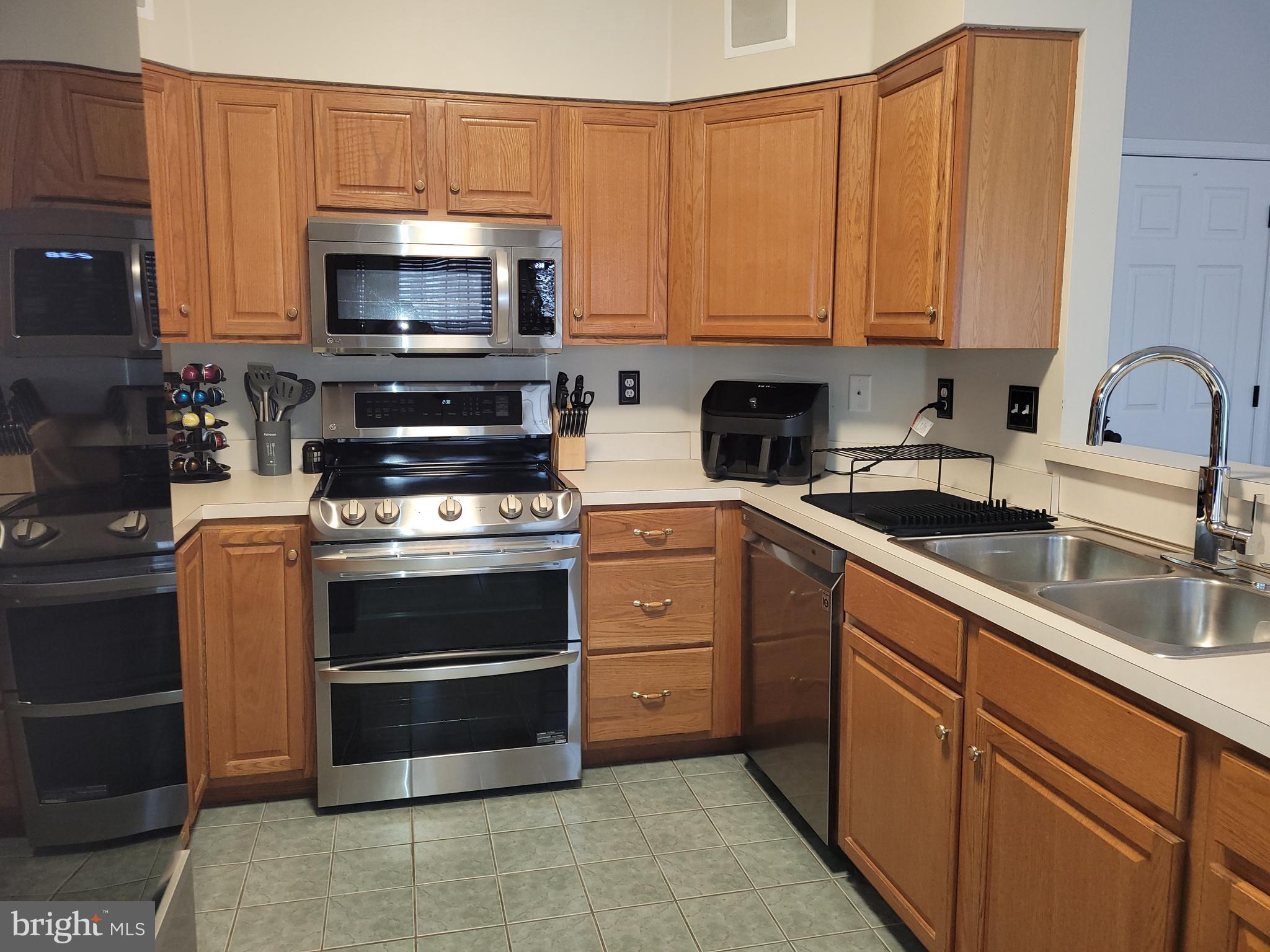 1045 Pond Ridge Drive Harrisburg, PA 17111 - Photo 2 of 25 a kitchen with cabinets stainless steel appliances and a sink