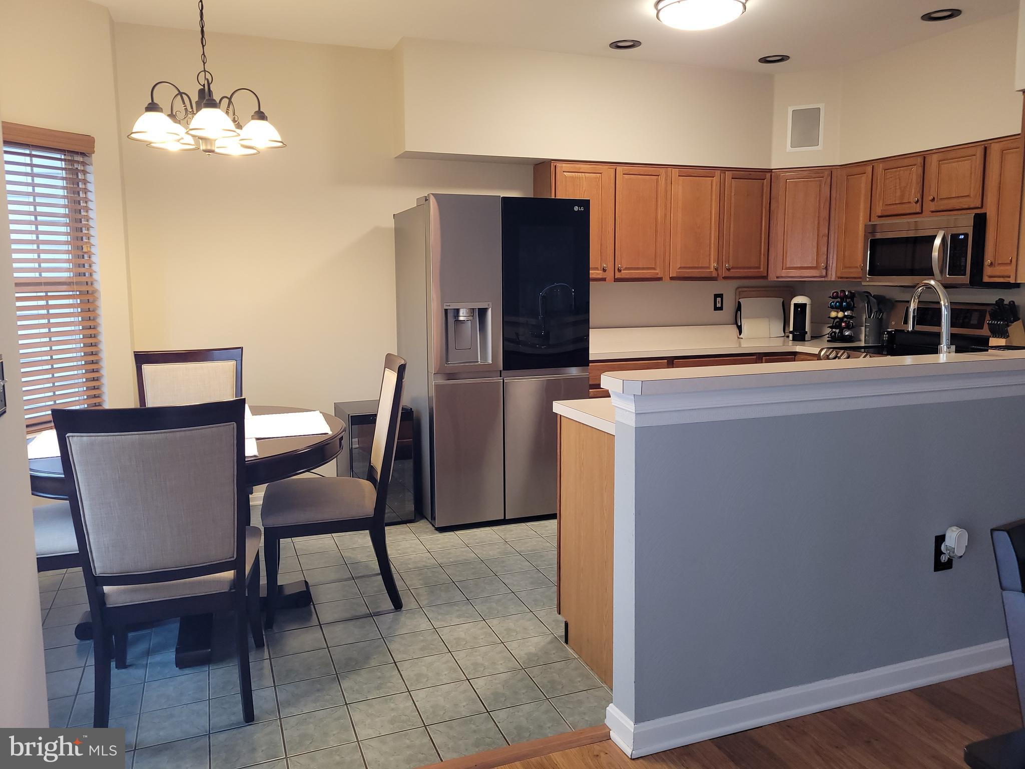 1045 Pond Ridge Drive Harrisburg, PA 17111 - Photo 3 of 25 a kitchen with stainless steel appliances granite countertop a sink a stove a refrigerator cabinets and chairs