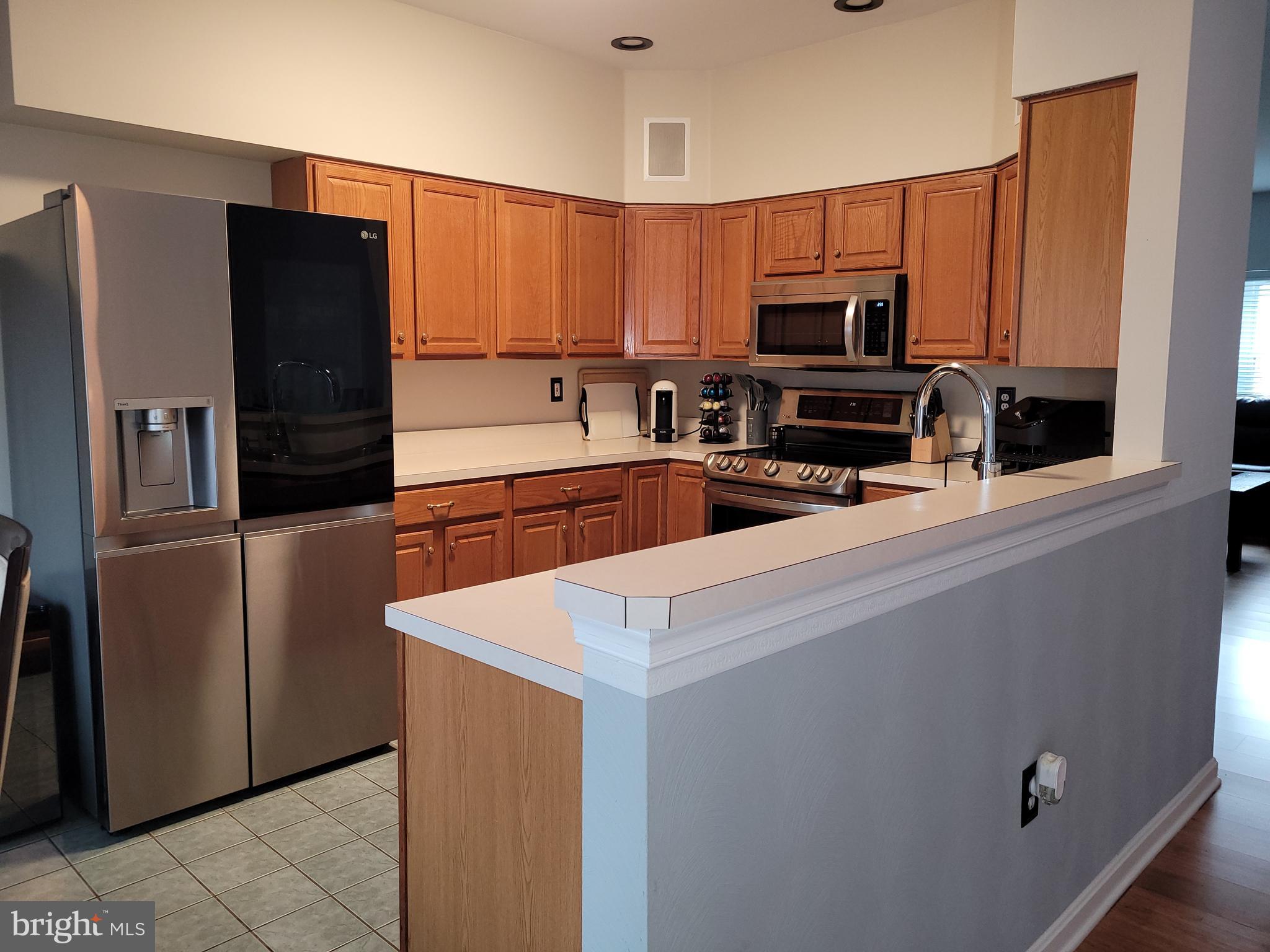 1045 Pond Ridge Drive Harrisburg, PA 17111 - Photo 4 of 25 a kitchen with granite countertop a refrigerator and a stove top oven