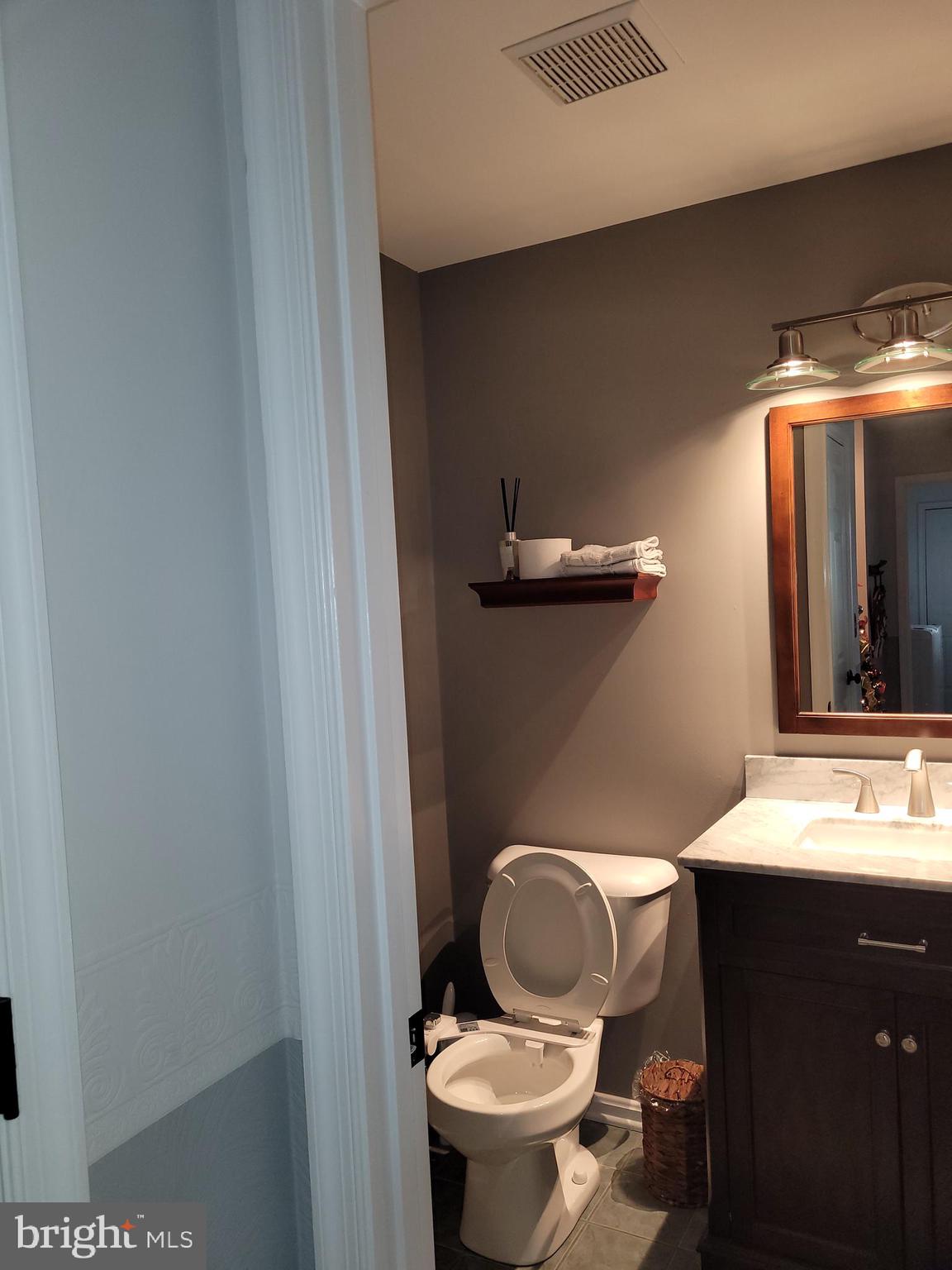 1045 Pond Ridge Drive Harrisburg, PA 17111 - Photo 8 of 25 a bathroom with a toilet mirror and vanity