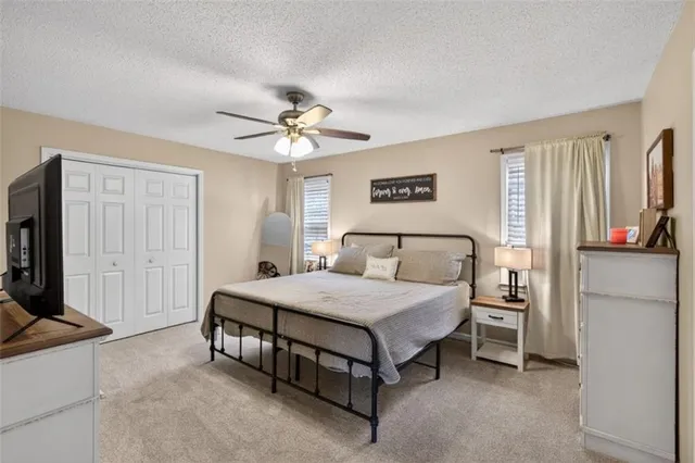 a spacious bedroom with a bed and a chandelier