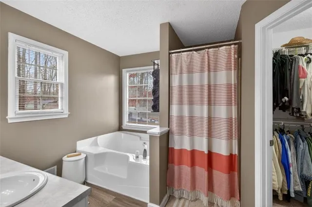 a bathroom with a bathtub and a shower