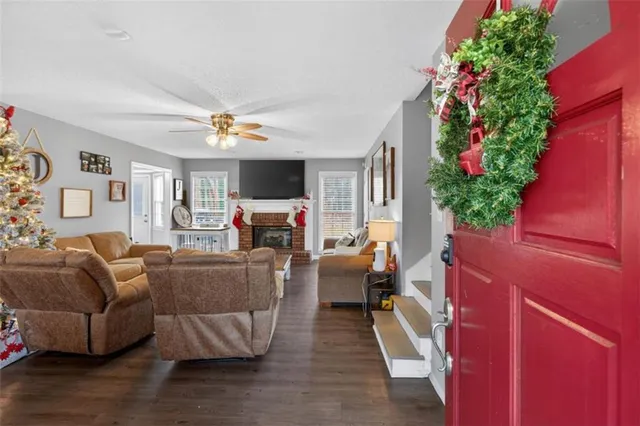a living room with furniture a flower pot and a fireplace