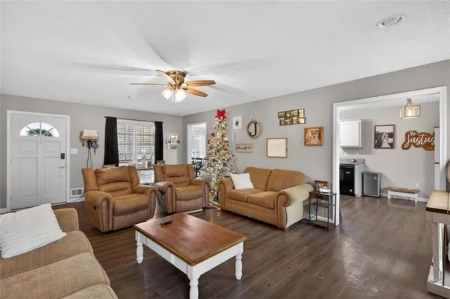 a living room with furniture chandelier and a table