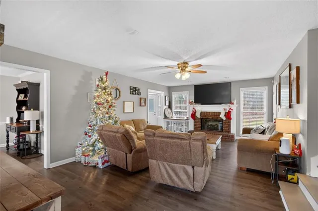 a living room with furniture a fireplace and a flat screen tv