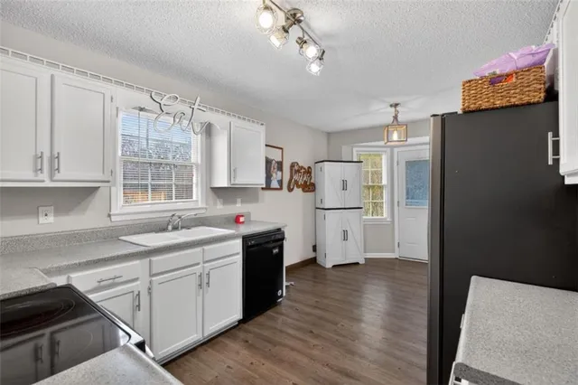 a kitchen with cabinets and wooden floor