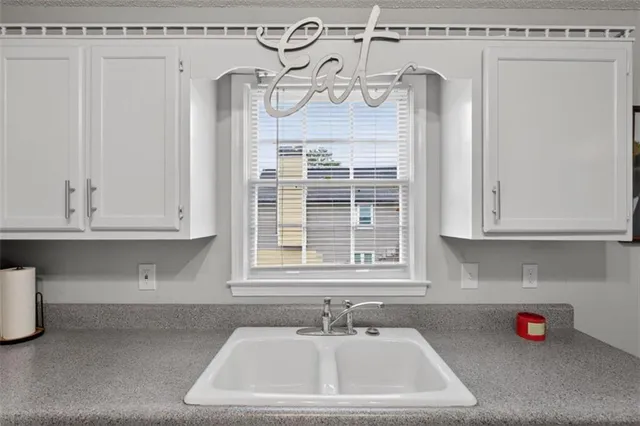 a bathroom with a sink and a window