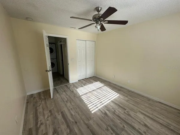 a view of a room with wooden floor and white walls