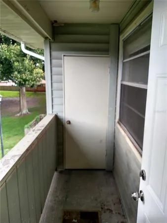 a view of a house with a backyard porch and sitting area