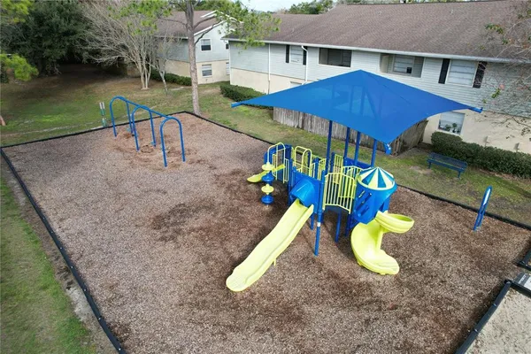 a swimming pool view with a seating space and a garden