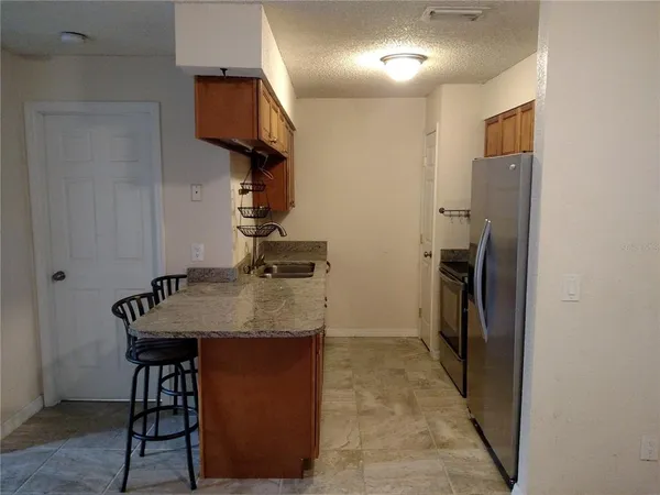 a kitchen with a refrigerator and a sink