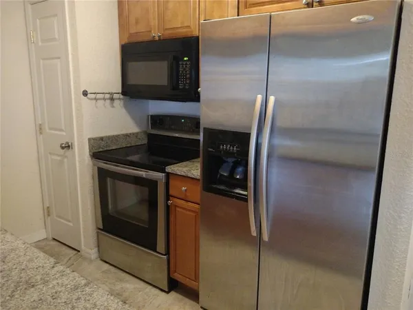 a kitchen with a refrigerator and a sink