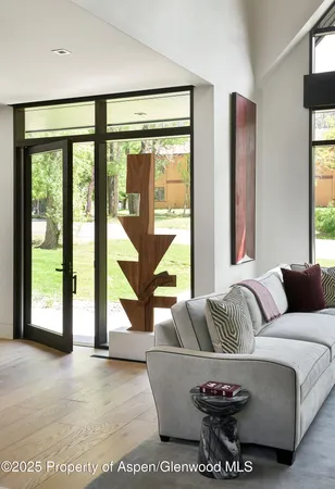 a living room with furniture and large windows