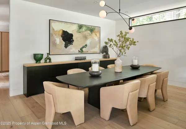 a dining room with furniture and wooden floor
