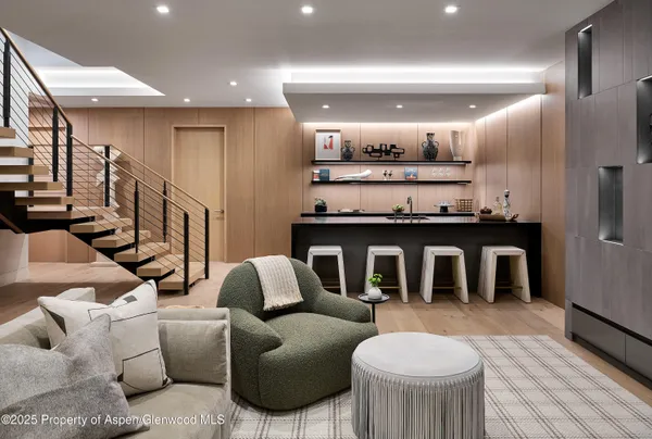 a kitchen with cabinets a sink and chairs in it