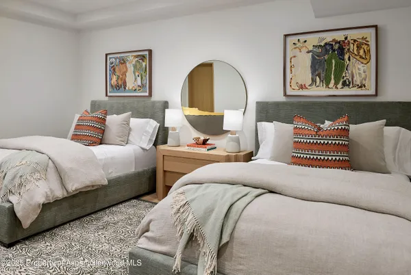 a living room with a couch and paintings on the wall
