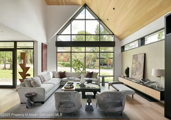 a living room with furniture and large windows