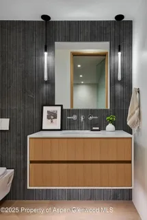 a bedroom with a bed and painting on the wall