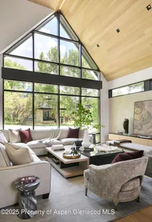 a living room with furniture and large windows