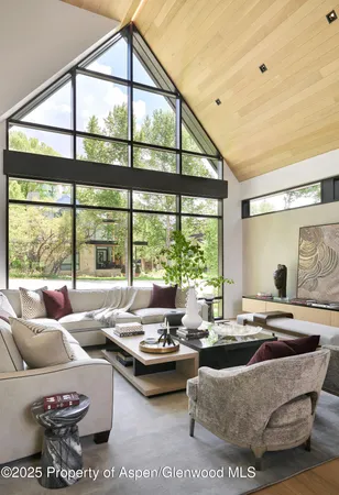 a living room with furniture and large windows