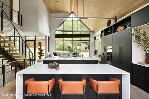 a kitchen with a sink and large window