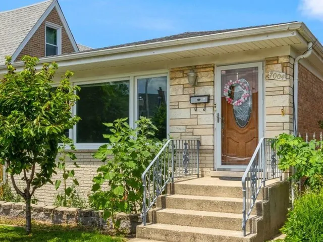 a front view of a house with potted plants
