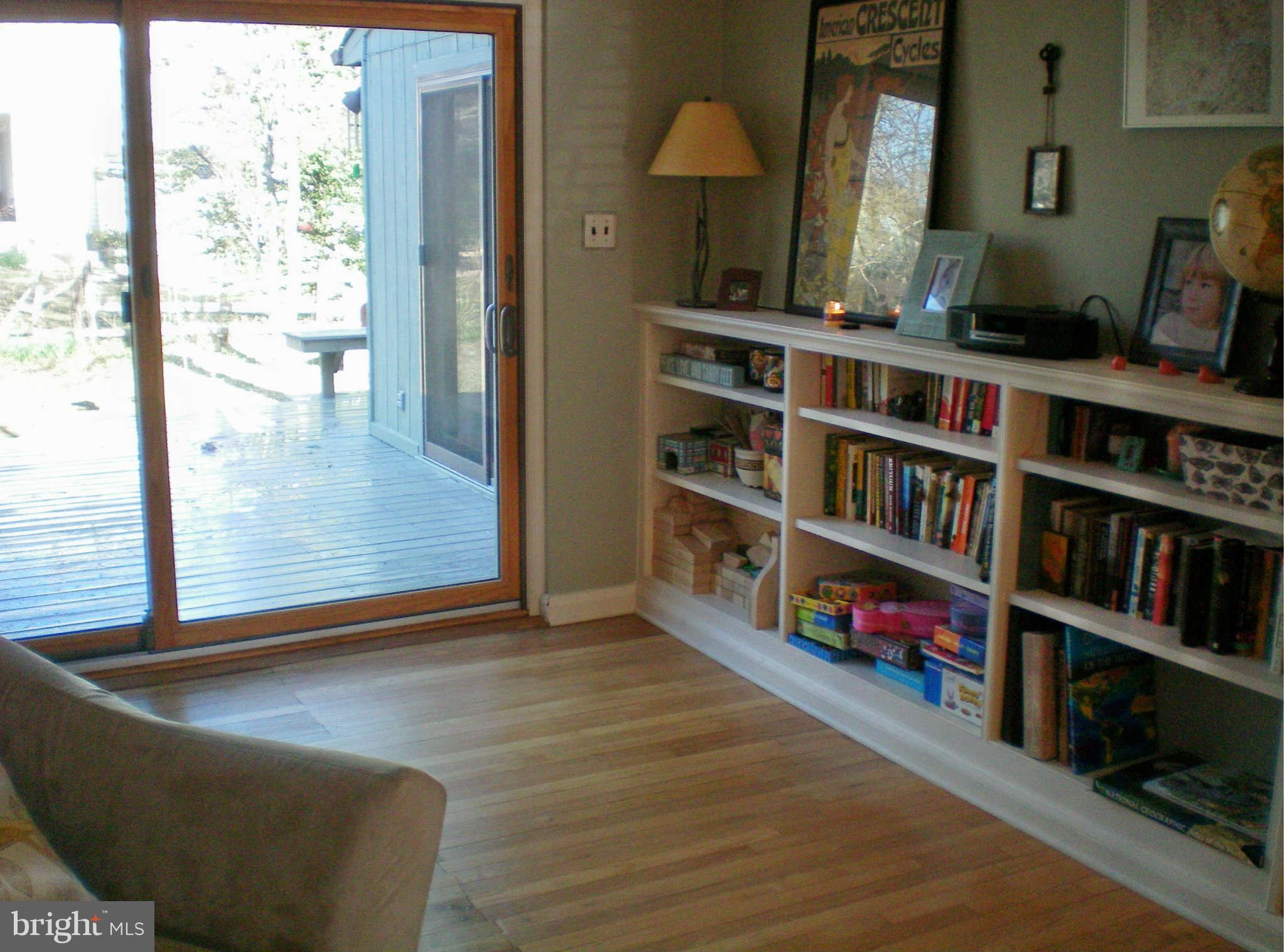 2508 Pinebrush Road Baltimore, MD 21209 - Photo 15 of 30 a living room with lots of books and a large window