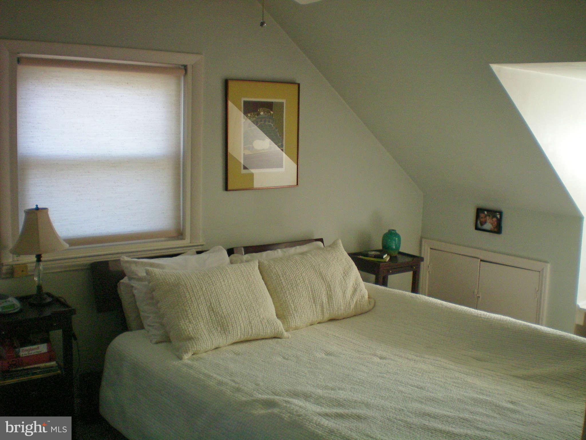 2508 Pinebrush Road Baltimore, MD 21209 - Photo 17 of 30 a bed sitting in a bedroom next to a window