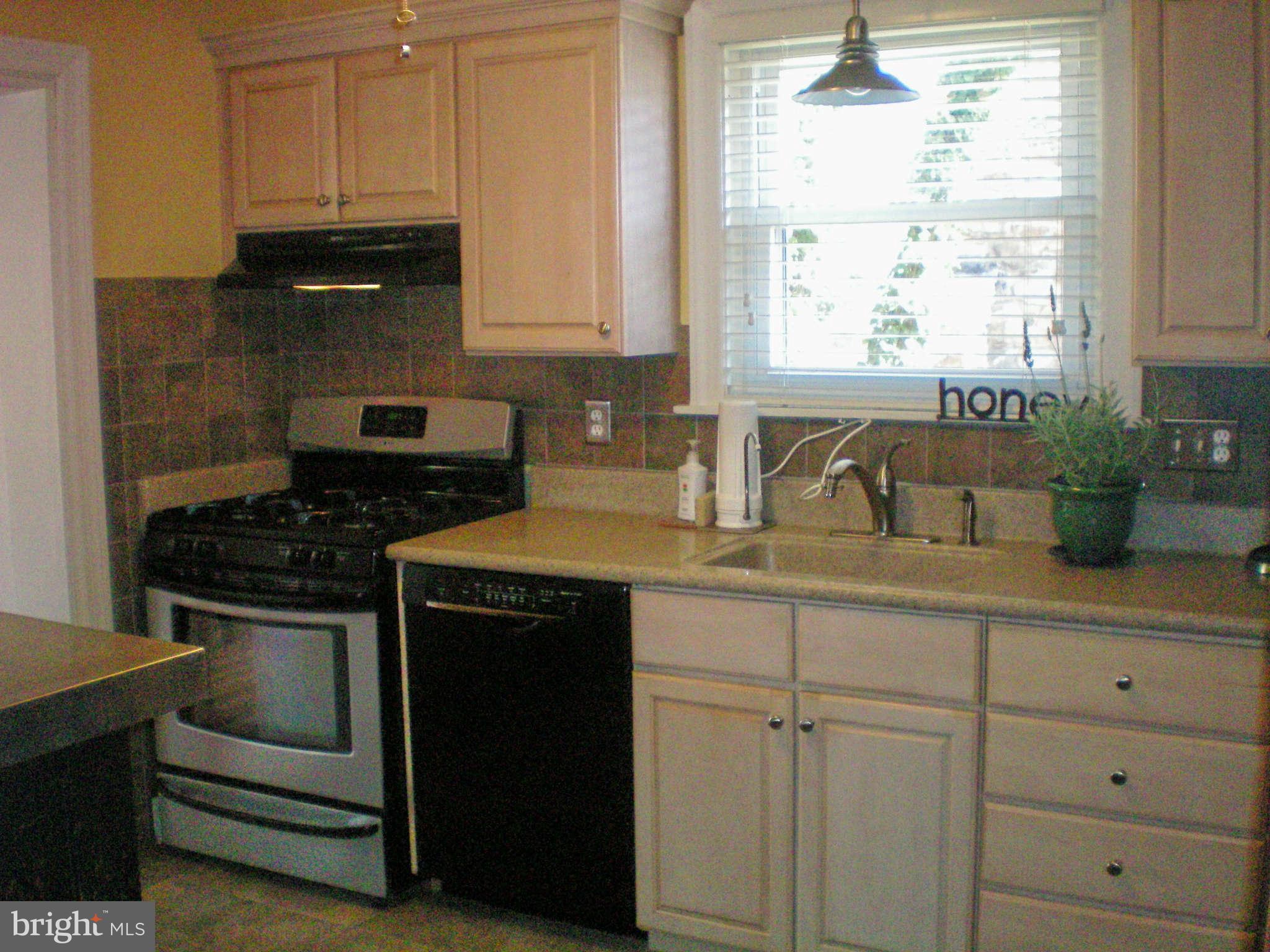 2508 Pinebrush Road Baltimore, MD 21209 - Photo 5 of 30 a kitchen with white cabinets and appliances