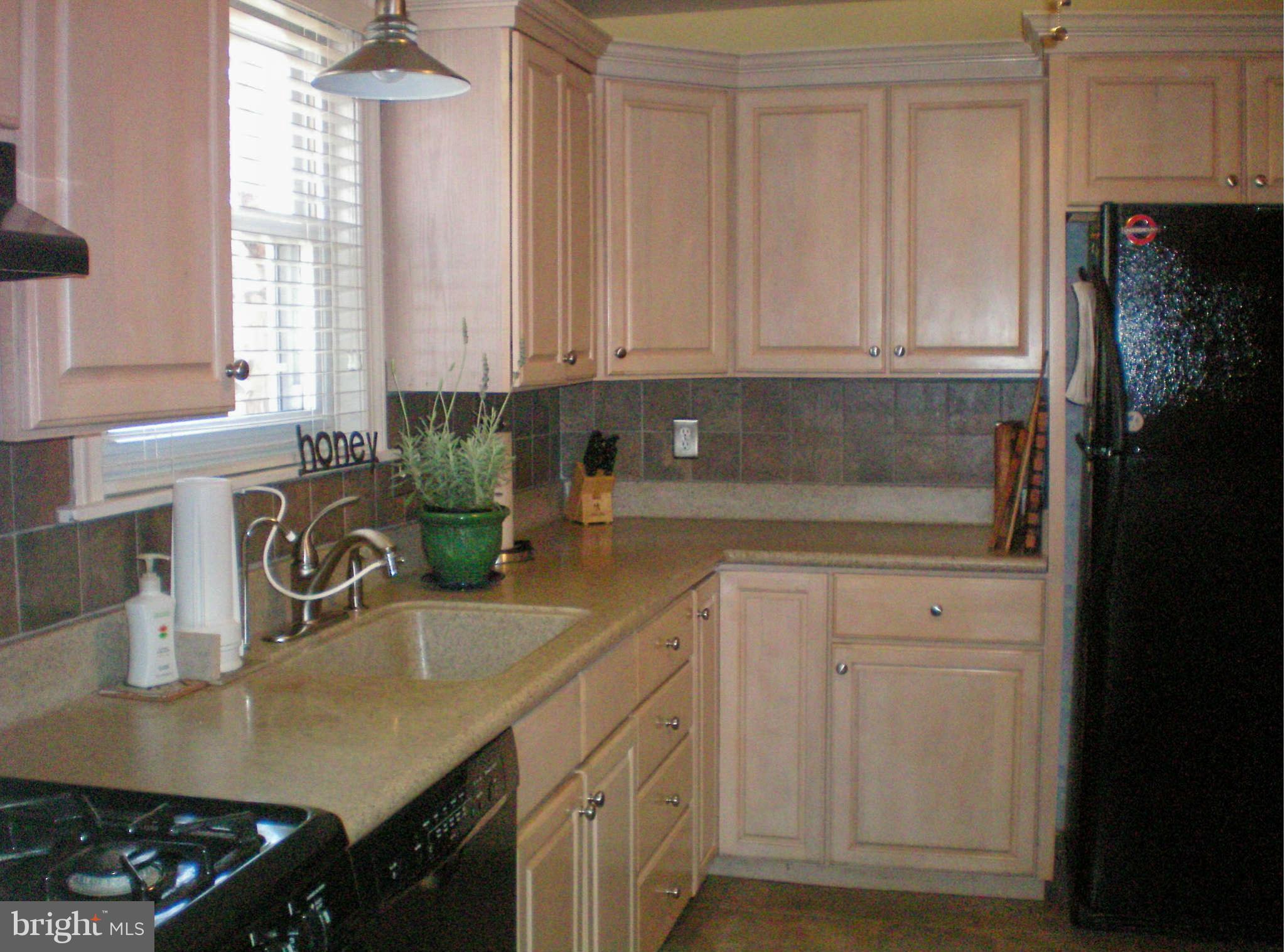2508 Pinebrush Road Baltimore, MD 21209 - Photo 6 of 30 a kitchen with stainless steel appliances granite countertop a sink a stove and a white cabinets
