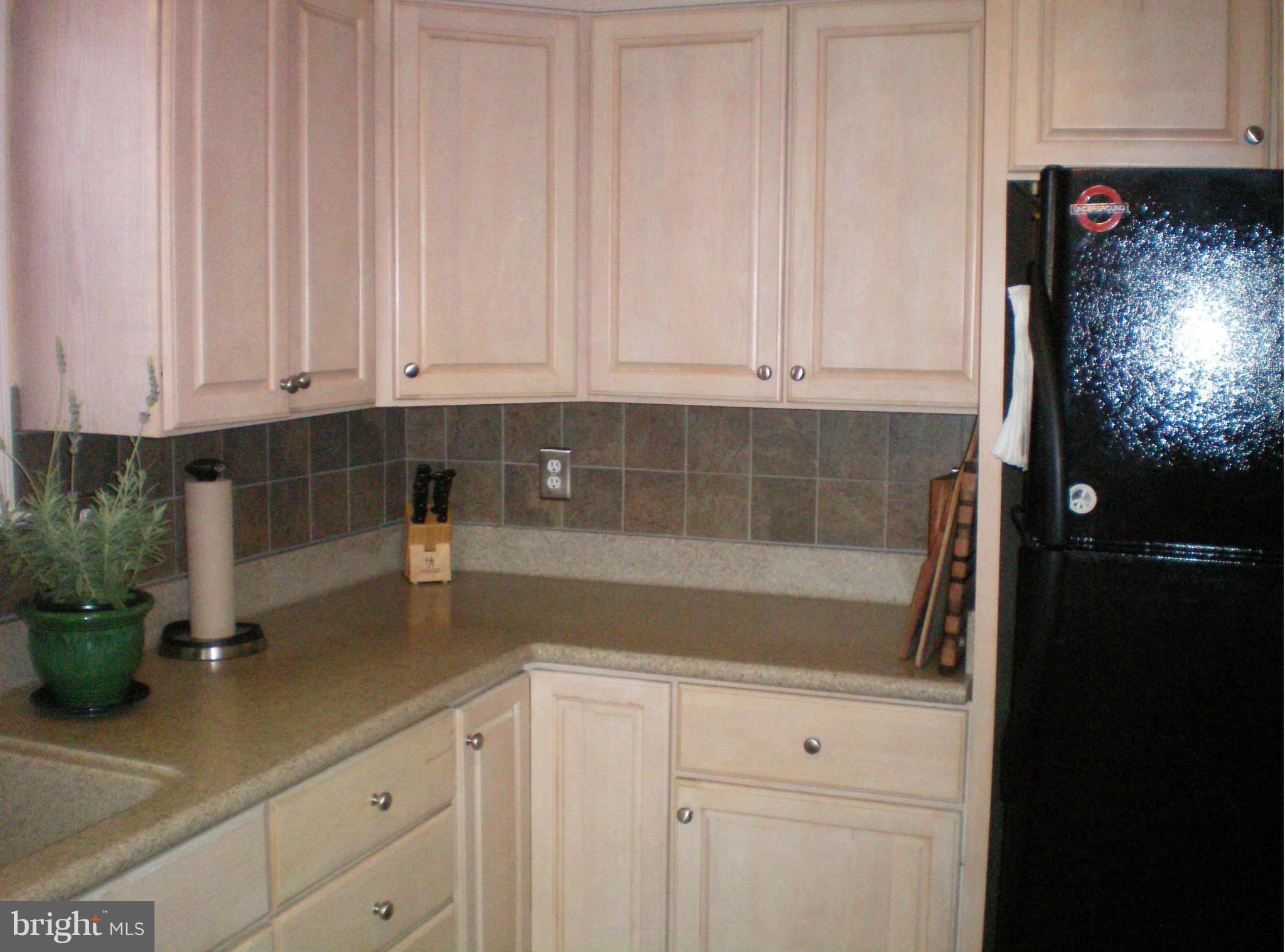 2508 Pinebrush Road Baltimore, MD 21209 - Photo 7 of 30 a kitchen with stainless steel appliances white cabinets and a sink