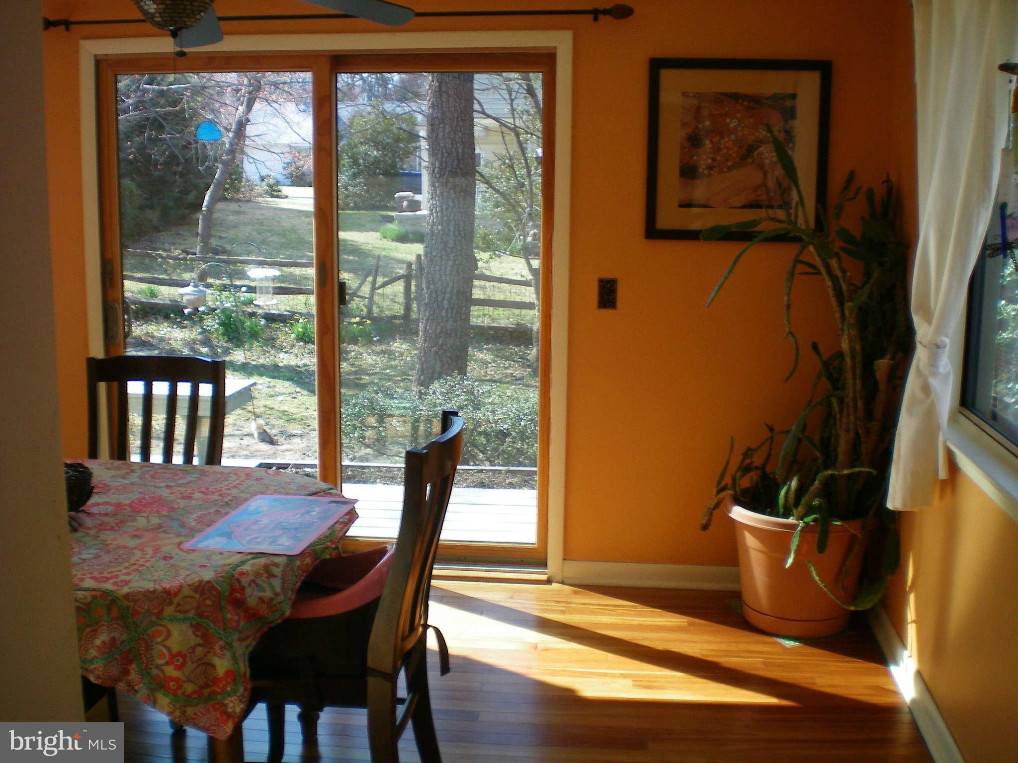 2508 Pinebrush Road Baltimore, MD 21209 - Photo 9 of 30 a view of a dining room with furniture a potted plant and wooden floor