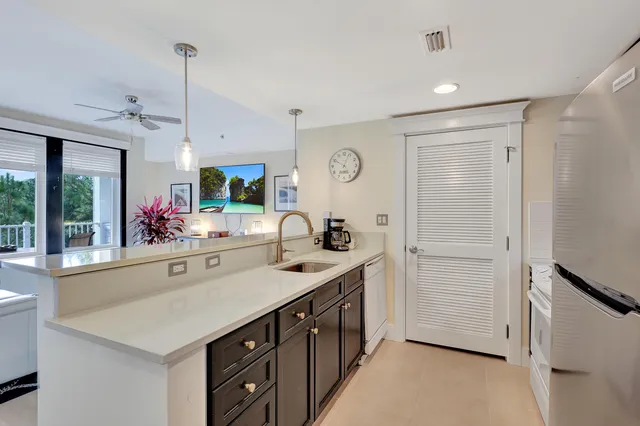 a kitchen with stainless steel appliances a sink and a refrigerator