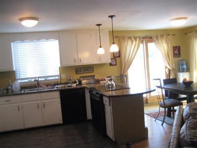 33 James Otis Road Centerville, MA 02632 - Photo 3 of 8 a kitchen with stainless steel appliances granite countertop a sink a stove and a wooden floors