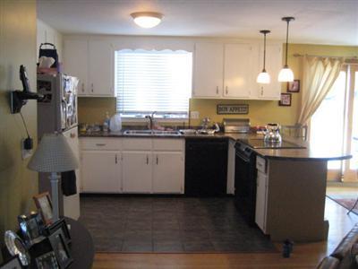 33 James Otis Road Centerville, MA 02632 - Photo 4 of 8 a kitchen with stainless steel appliances granite countertop a sink a stove and a refrigerator
