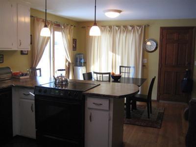 33 James Otis Road Centerville, MA 02632 - Photo 5 of 8 a kitchen with a sink a window and chairs